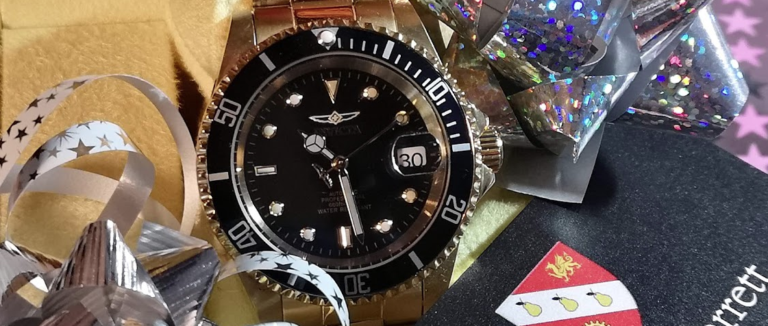 image of submariner style watch in box with gift wrap